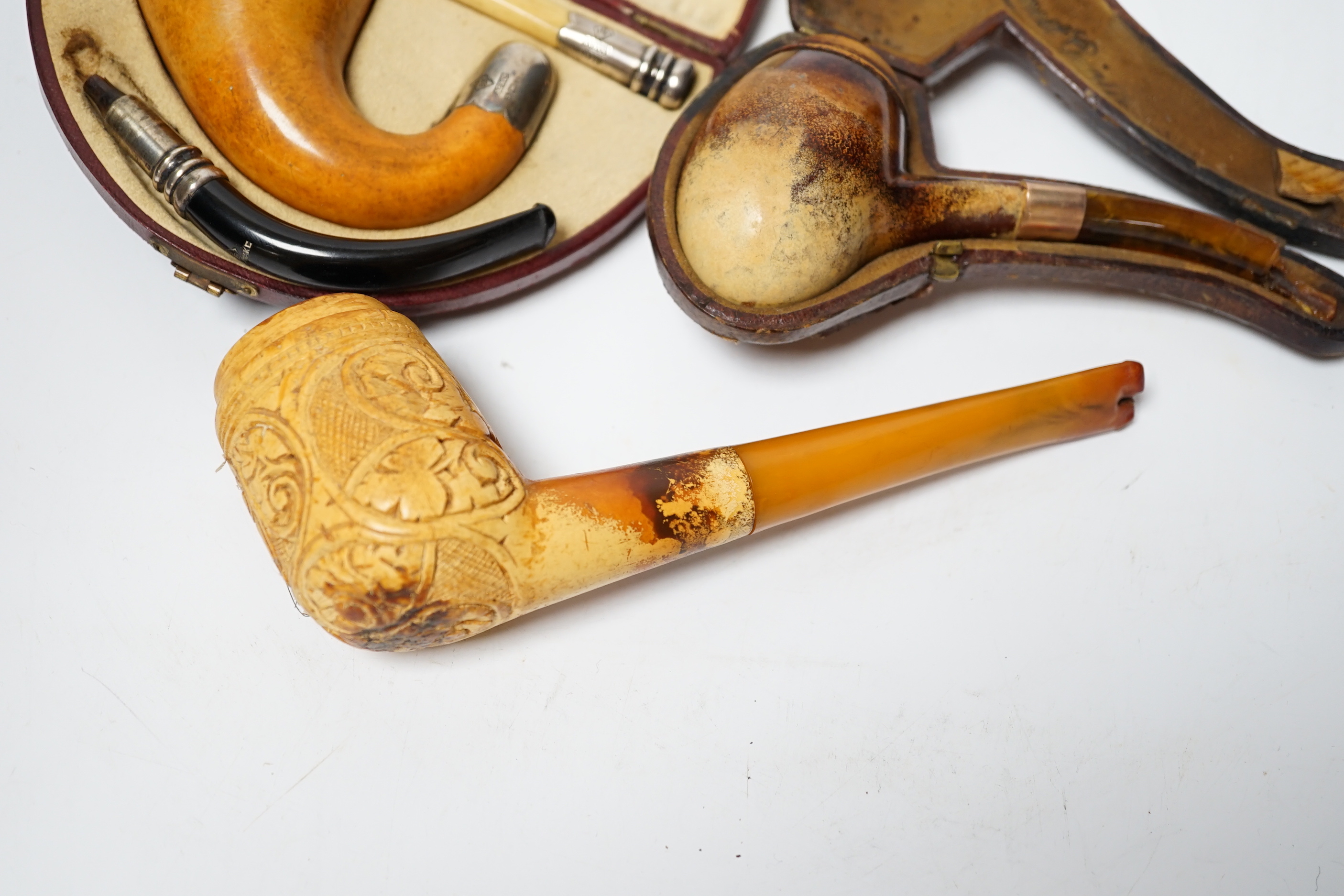 Three Meerschaum pipes, one 9ct gold mounted, one silver mounted, two cases